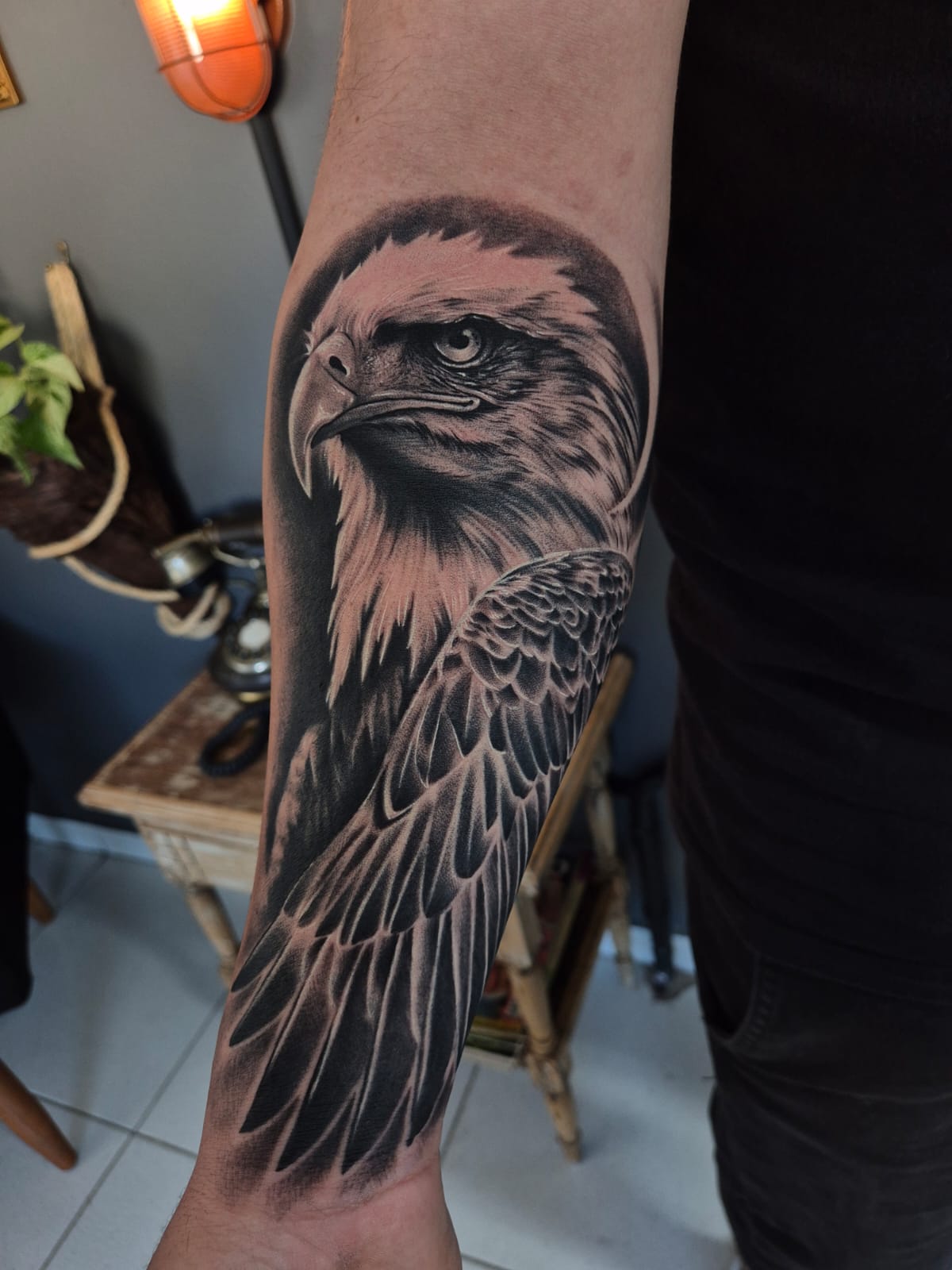 Tatuagem realista de águia no antebraço